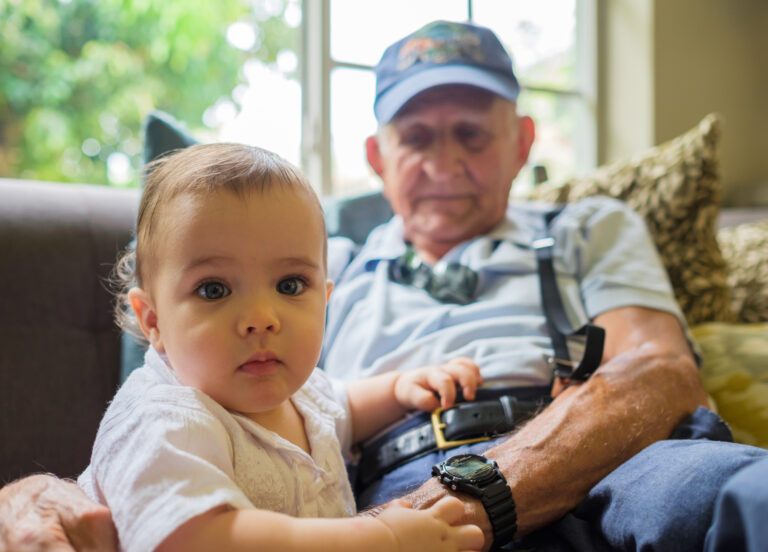 Cute baby boy with great grandfather in an assisted living.