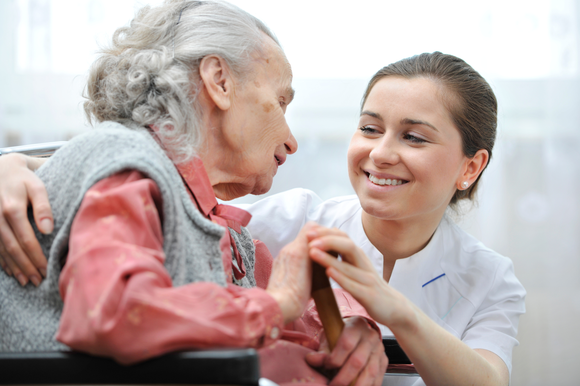 Senior woman with her caregiver at home