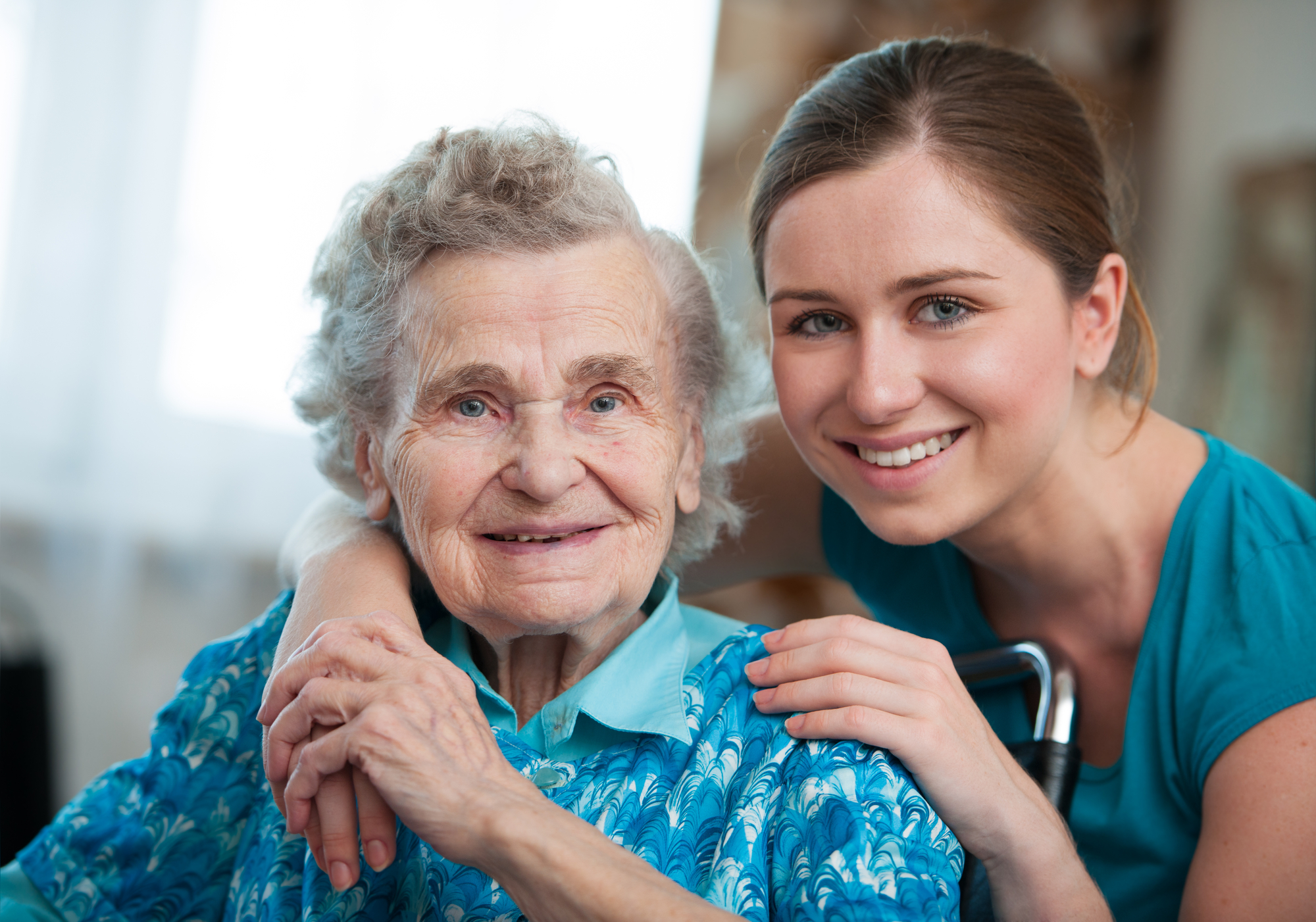 Senior woman with her caregiver at home